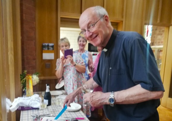 Cutting cake at St. Barnabas Church Bexhill. Fr. Martin Harper celebrates 40-years of ministering.